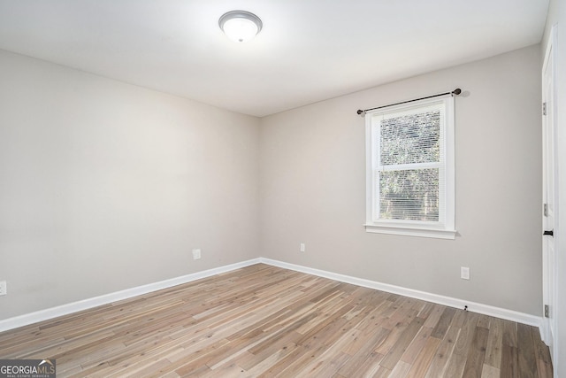 empty room with light hardwood / wood-style flooring