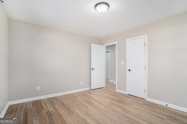 unfurnished room with light hardwood / wood-style floors