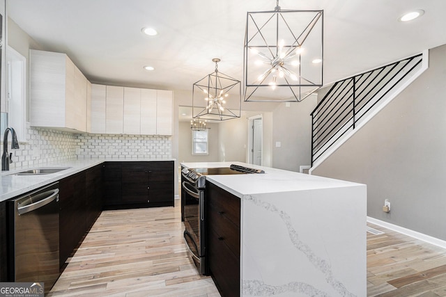 kitchen with sink, a center island, stainless steel dishwasher, black range with electric cooktop, and pendant lighting