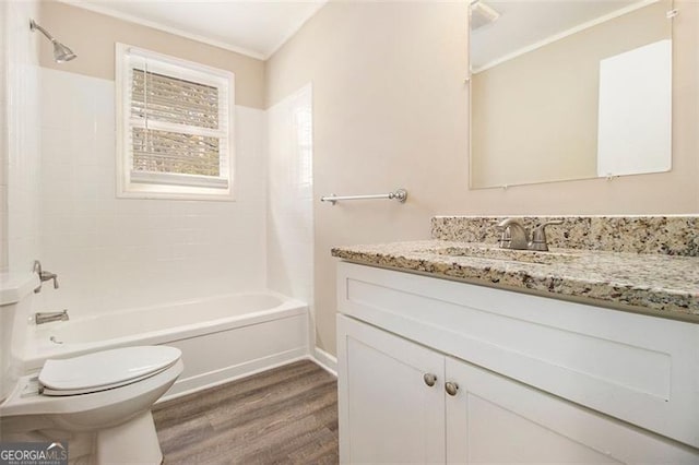 full bathroom with washtub / shower combination, vanity, toilet, and hardwood / wood-style floors