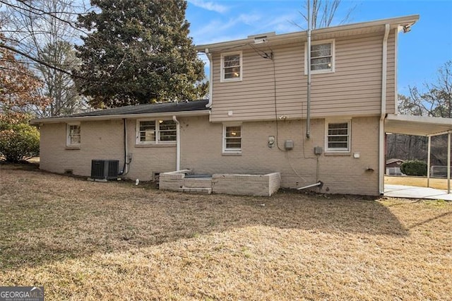 back of house featuring a carport, central AC, and a lawn