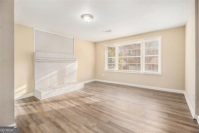 unfurnished living room featuring hardwood / wood-style floors