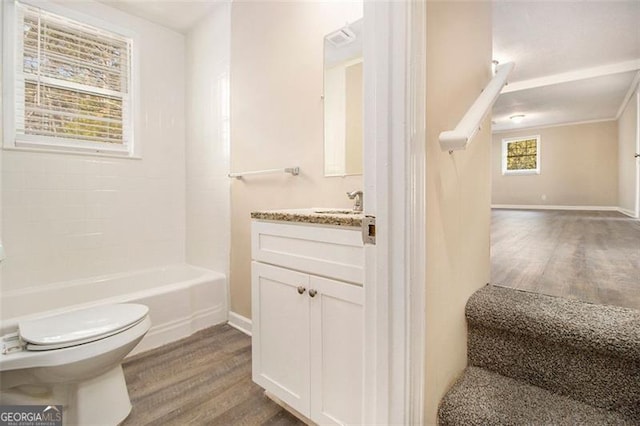 full bathroom featuring hardwood / wood-style flooring, shower / bathtub combination, vanity, and toilet