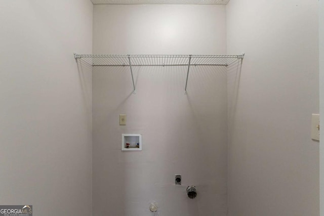 laundry area with hookup for a gas dryer, hookup for a washing machine, a textured ceiling, and electric dryer hookup