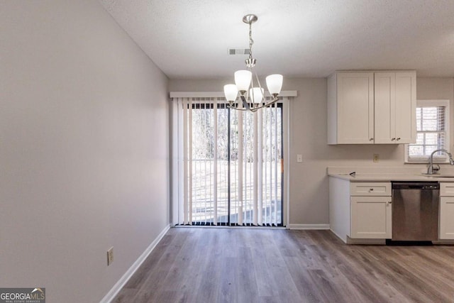 kitchen with sink, decorative light fixtures, stainless steel dishwasher, and white cabinets