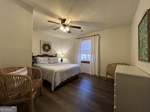 bedroom with ceiling fan, dark hardwood / wood-style floors, and a textured ceiling