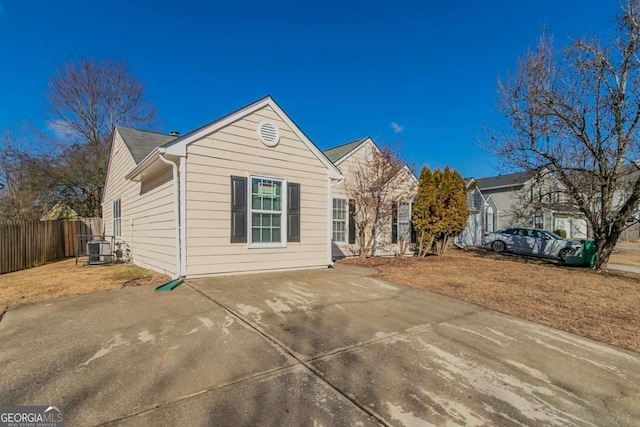 view of front of property featuring central AC unit and a patio