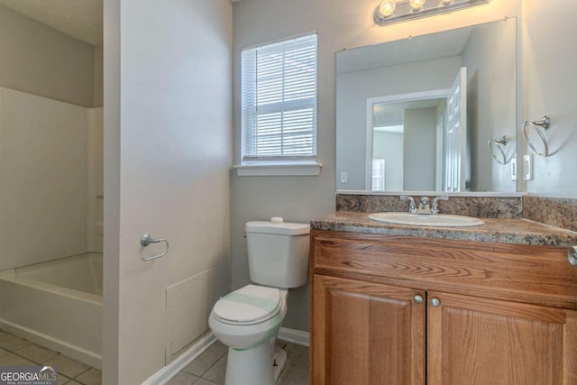 bathroom featuring vanity, tile patterned floors, and toilet