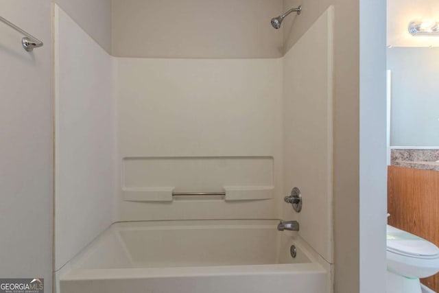 bathroom featuring toilet and shower / bathing tub combination