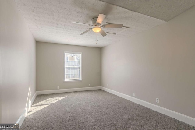 carpeted spare room with ceiling fan and a textured ceiling