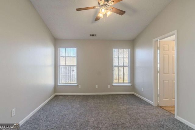 carpeted empty room featuring vaulted ceiling and ceiling fan