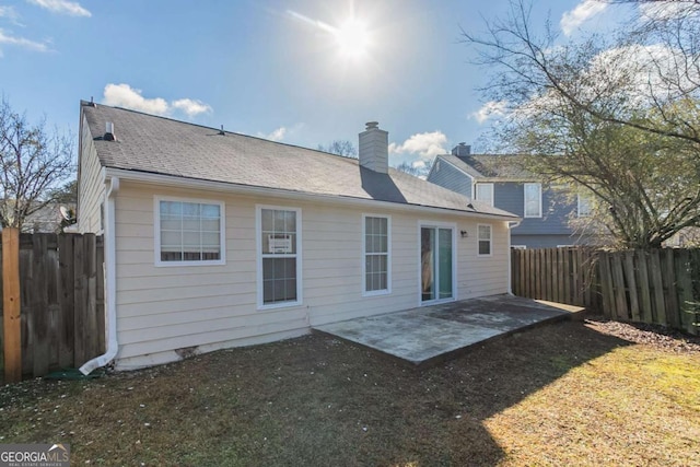 rear view of house featuring a patio area and a lawn