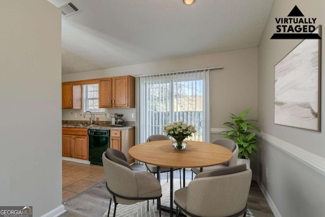 dining area with sink and light hardwood / wood-style floors