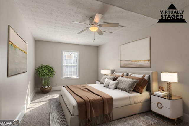 carpeted bedroom with ceiling fan and a textured ceiling