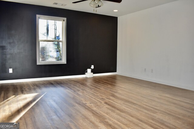 unfurnished room with hardwood / wood-style flooring and ceiling fan