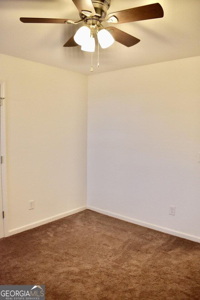 carpeted spare room with ceiling fan