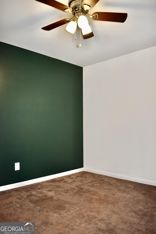 unfurnished room featuring ceiling fan and carpet floors