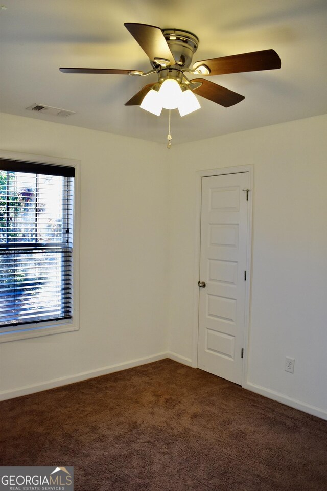 carpeted empty room with ceiling fan