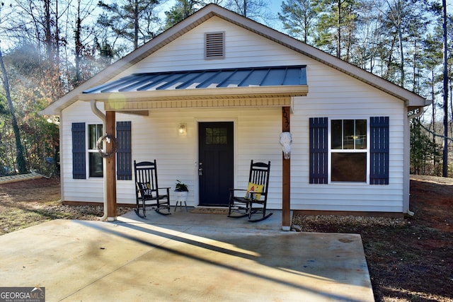 back of house featuring a patio and covered porch