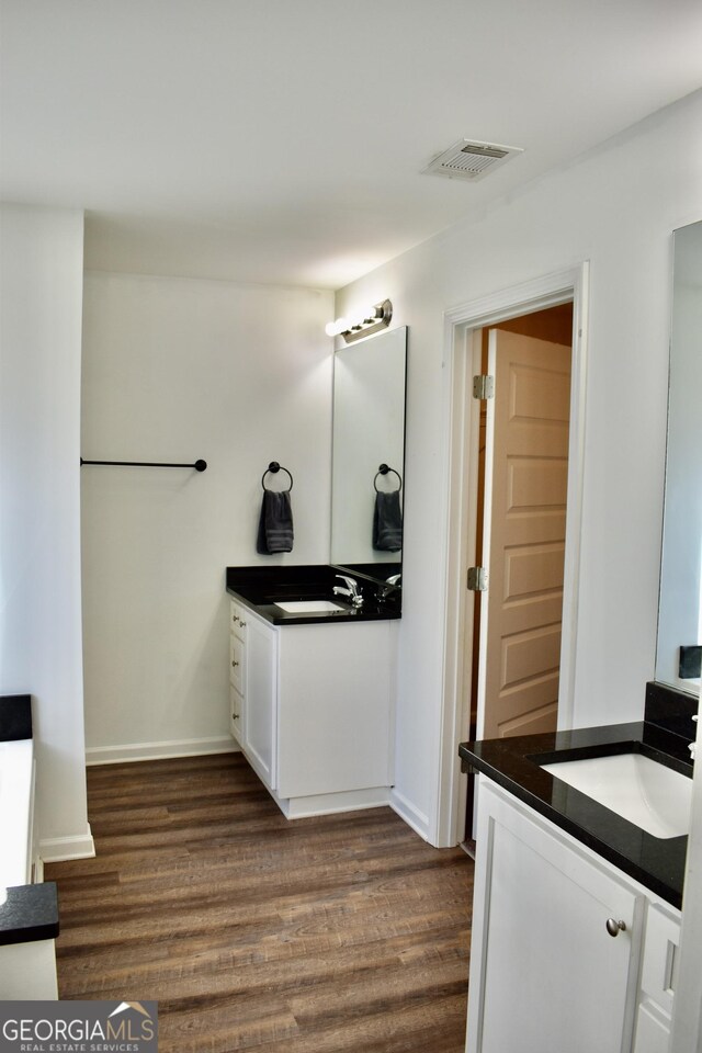 bathroom with wood-type flooring and vanity