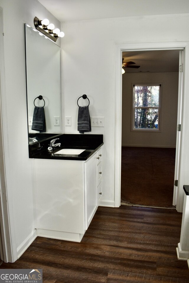 bathroom featuring vanity, hardwood / wood-style floors, and ceiling fan