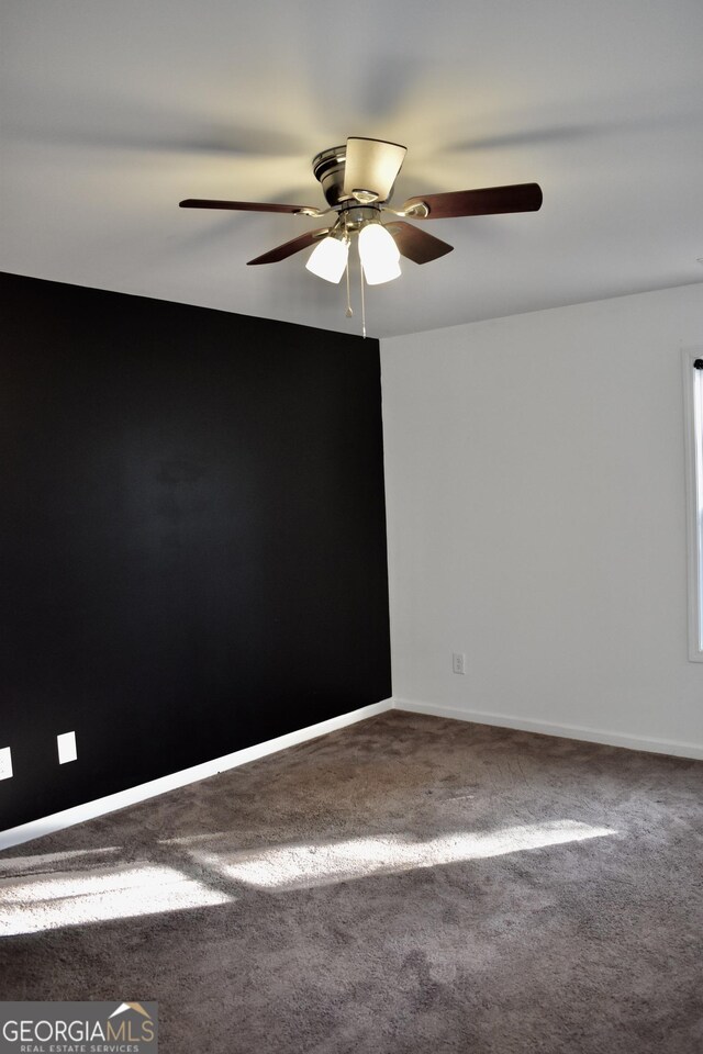 empty room featuring ceiling fan and carpet flooring