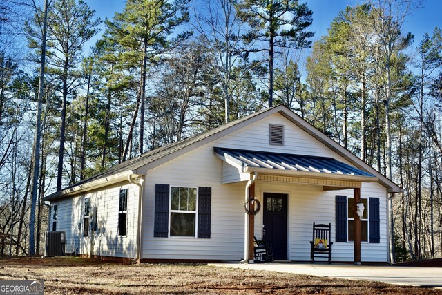 view of front of home with central AC and a porch