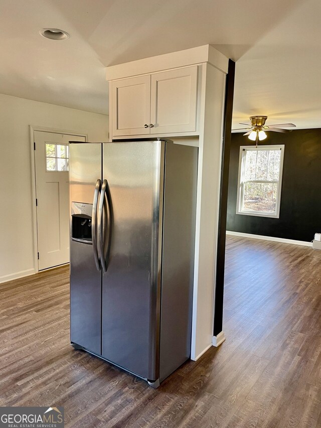 kitchen with ceiling fan, dark hardwood / wood-style flooring, stainless steel fridge with ice dispenser, and white cabinets