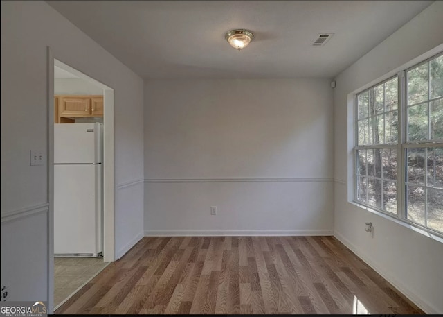 spare room with hardwood / wood-style flooring