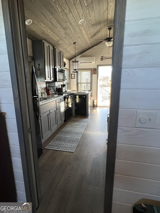 kitchen featuring lofted ceiling, wooden ceiling, a wall unit AC, pendant lighting, and black appliances