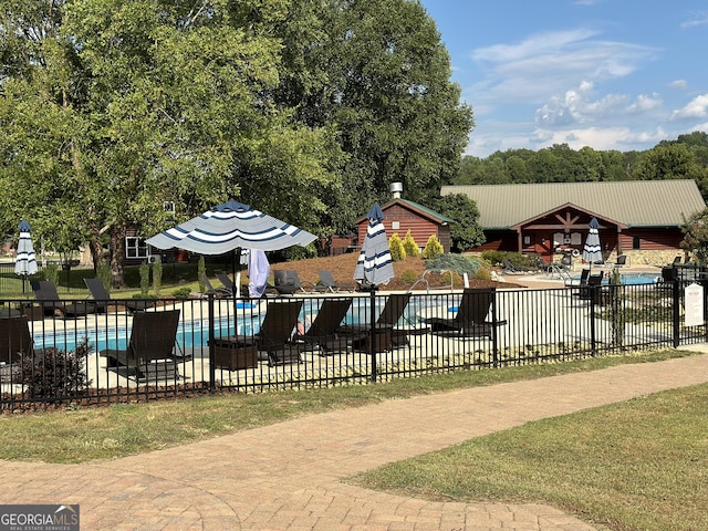 view of swimming pool featuring a patio area