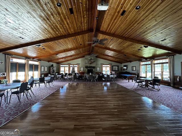 unfurnished dining area featuring dark hardwood / wood-style flooring, beam ceiling, and a wealth of natural light