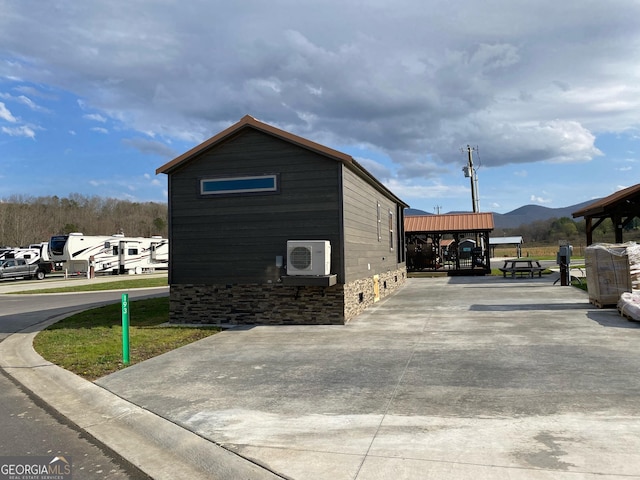 view of side of property featuring a mountain view and ac unit