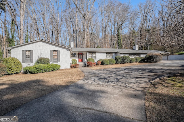 ranch-style house featuring a carport