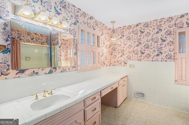 bathroom featuring tile walls, vanity, tile patterned floors, and a shower