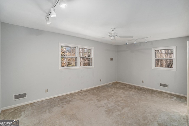 spare room featuring ceiling fan and light colored carpet