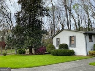 view of home's exterior with a yard