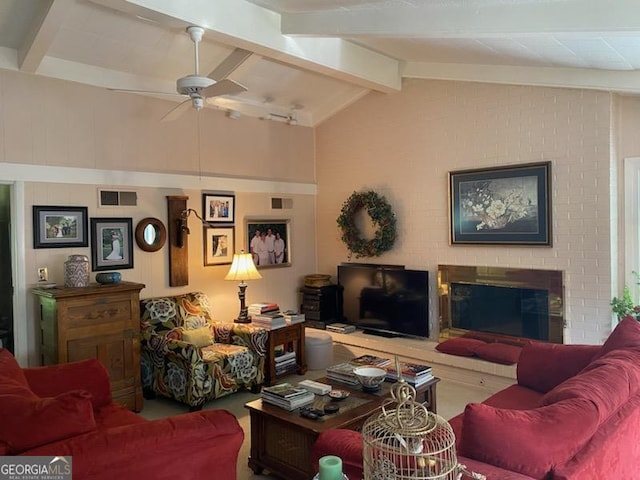 living room featuring lofted ceiling with beams, a brick fireplace, and ceiling fan