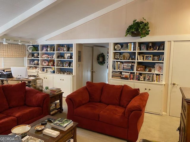 living room with vaulted ceiling with beams, light colored carpet, and built in shelves