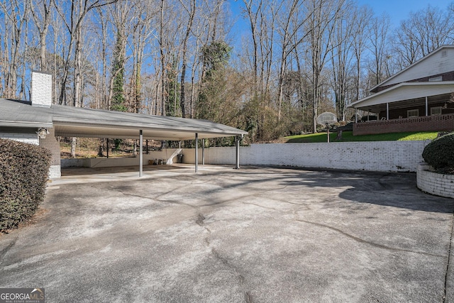 view of parking / parking lot with a carport