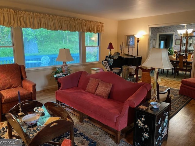 living room with hardwood / wood-style flooring and a notable chandelier