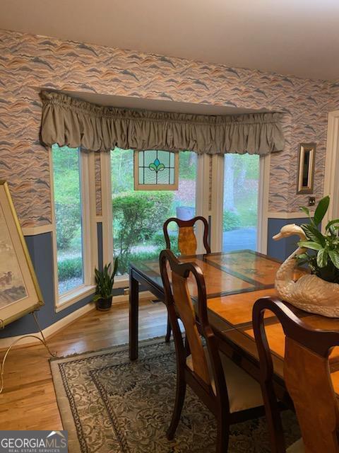 dining room featuring wood-type flooring and plenty of natural light