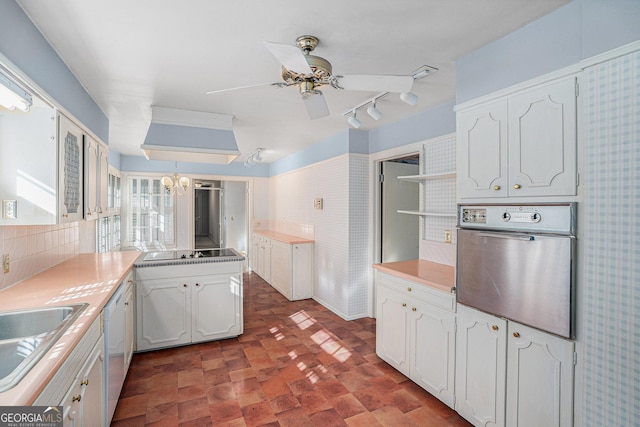 kitchen with white cabinetry, decorative light fixtures, white dishwasher, black electric stovetop, and oven