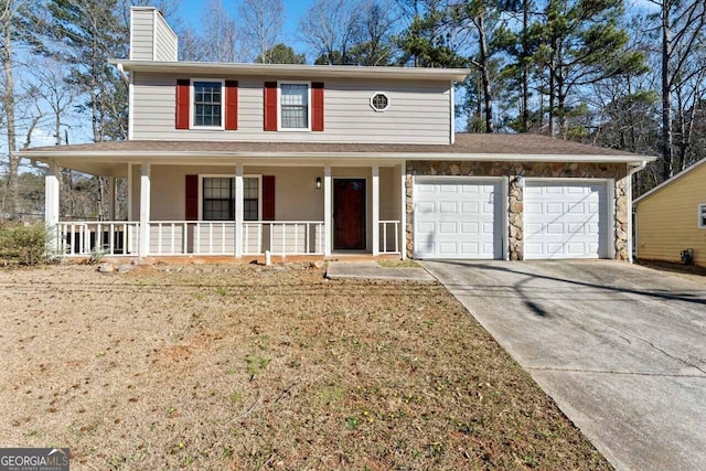 view of front of home featuring a chimney, covered porch, an attached garage, stone siding, and driveway