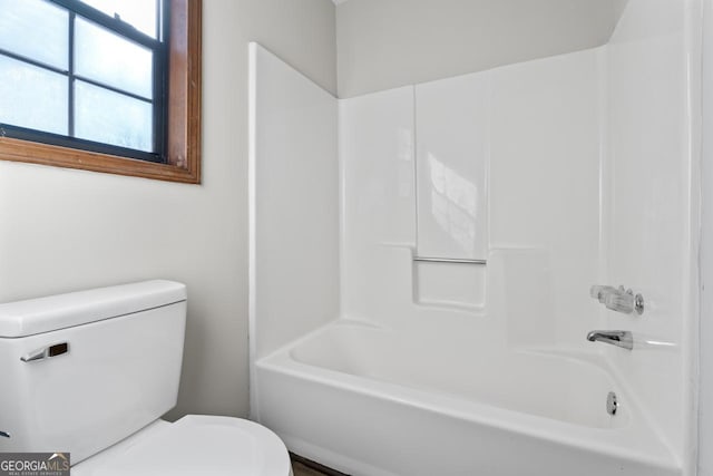 full bathroom featuring shower / bath combination and toilet