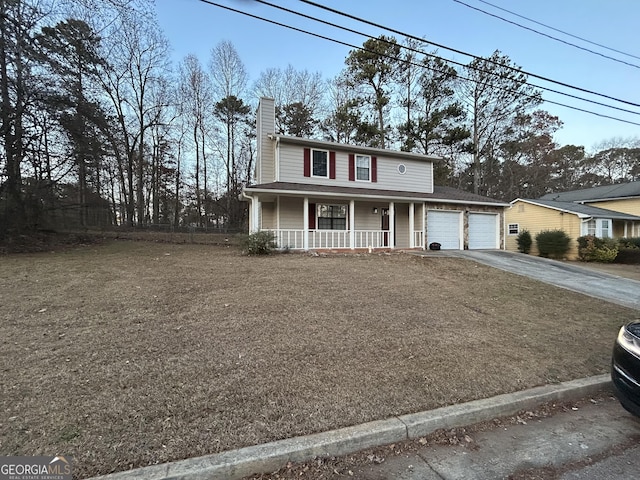 front of property featuring a porch and a garage