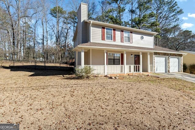 view of front of home with a garage, driveway, a chimney, and a porch