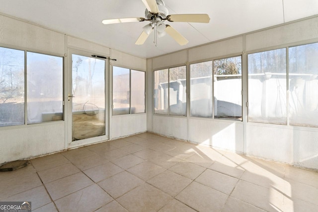 unfurnished sunroom featuring ceiling fan