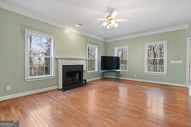 unfurnished living room with crown molding, light hardwood / wood-style floors, and ceiling fan