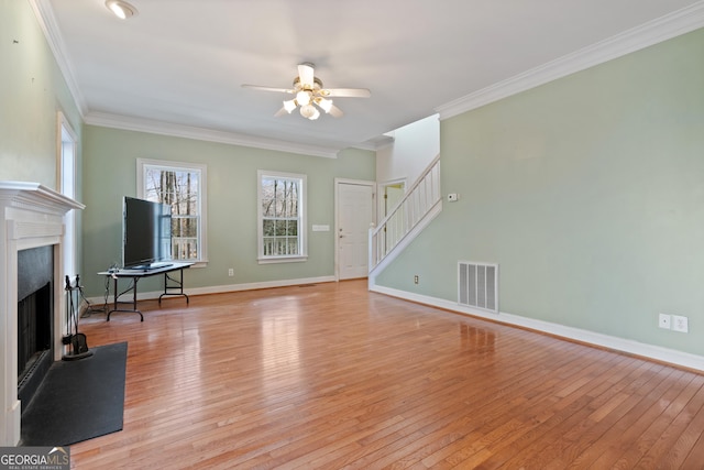 living room featuring ornamental molding, light hardwood / wood-style floors, and ceiling fan